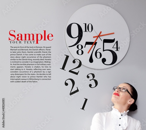 Photo: Business Woman under the clock. Concept Business Woman under the clock. Concept
