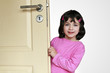 Little enjoys girl is hiding behind a door