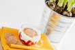 A cup of yogurt with macaroons on white background