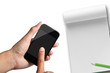 hand pressing smartphone with note paper.