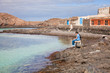 two brothers sitting in the small port of Isla de Lobos,  Canary