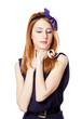 Beautiful redhead girl with paper hat over head.