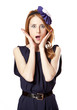 Beautiful redhead girl with paper hat over head.
