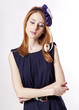 Beautiful redhead girl with paper hat over head.