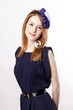Beautiful redhead girl with paper hat over head.