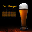 Beer into glass on a black and wooden table Beer into glass on a black and wooden table
