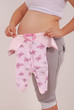 Pregnant woman holding baby clothes Pregnant woman holding baby clothes