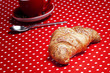 Croissant on red background