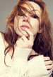 Beautiful young woman with her hair on face