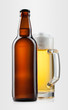 Beer into glass and bottle on a gray Beer into glass and bottle on a gray