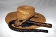 Foto: straw hat with a whip and a wooden smoking pipe straw hat with a whip and a wooden smoking pipe