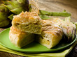 vegetarian quiche with artichoke on wood background
