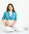 Beautiful pregnant woman in a plaid shirt