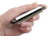 Harmonica in hand of man