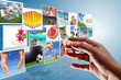 Foto: Streaming multimedia screen with reaching hand. Streaming multimedia screen with reaching hand.