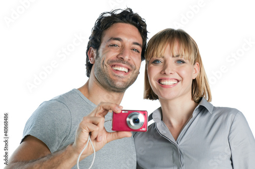 Photo: Smiling couple taking photos Smiling couple taking photos