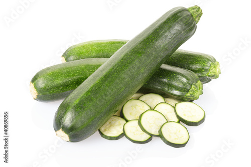 Photo: Zucchini or courgette sliced on white, clipping path i Zucchini or courgette sliced on white, clipping path i
