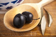 Olives over on the spoon Wooden Background Olives over on the spoon Wooden Background