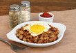 Fried egg on top of roast beef hash.