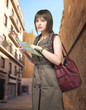 Young female tourist studying a map in Spain