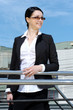 Cute young business woman in the office building balcony