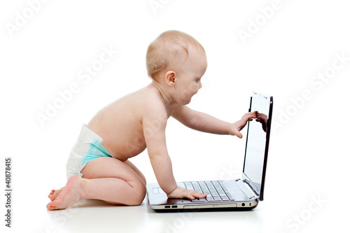 Photo: funny child playing a laptop funny child playing a laptop