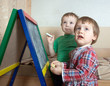 children draws on  blackboard with chalk
