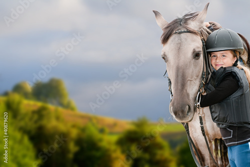 Photo: Horse riding - portrait of lovely equestrian with horse Horse riding - portrait of lovely equestrian with horse