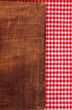 Rustic wooden background with red and white tablecloth