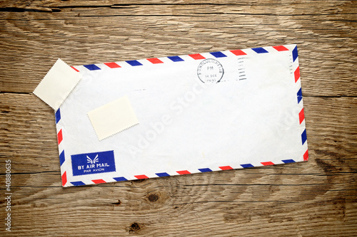 Photo: Old envelope on wooden background Old envelope on wooden background