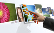 touchscreen interface: man hand reaching images on the screen