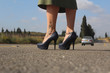 Woman with leg tattoo standing on the road