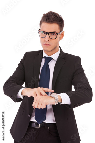 Photo: business man showing you that you are late business man showing you that you are late