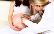 Pregnant woman with doctor in hospital - indoors