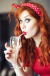 Funny girl drinking wine using straw. Funny girl drinking wine using straw.
