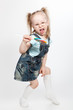 Capricious little girl with lollipop