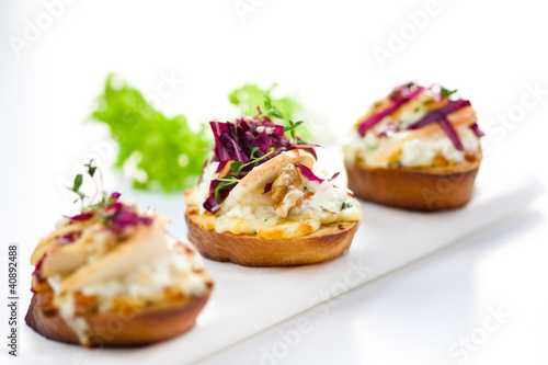 Photo: crostini appetizer with pear, radicchio and green salad crostini appetizer with pear, radicchio and green salad