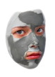 Photo: Sad teenager with grey cosmetic mask Sad teenager with grey cosmetic mask