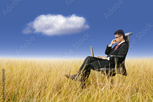 Photo: Cloud Computing: Businessman working anywhere with laptop Cloud Computing: Businessman working anywhere with laptop