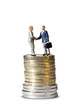 Miniature handshake euro coin tower
