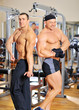 Two bodybuilders posing at the gym