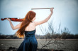 Photo: The red-haired girl with a violin outdoor The red-haired girl with a violin outdoor