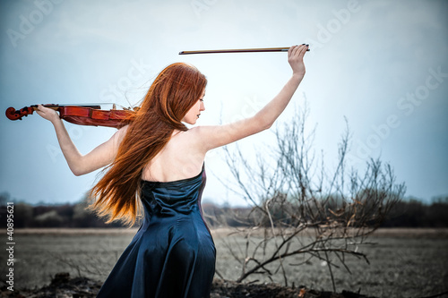 Photo: The red-haired girl with a violin outdoor The red-haired girl with a violin outdoor