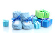 beautiful gifts and baby's bootees isolated on white