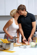 couple in their kitchen making dinner