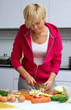 young lady making salad in kitchen