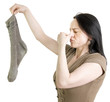 woman with dirty sock holding her nose