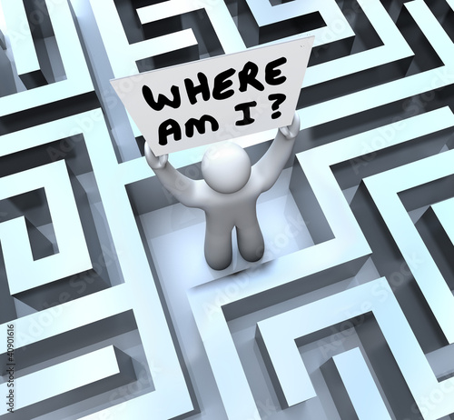 Photo: Where Am I Person Holding Sign Lost in Maze Where Am I Person Holding Sign Lost in Maze