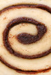 Macro of cinnamon bun swirl with selective focus on center.