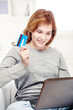 Foto: Happy girl doing on line shopping with credit card Happy girl doing on line shopping with credit card